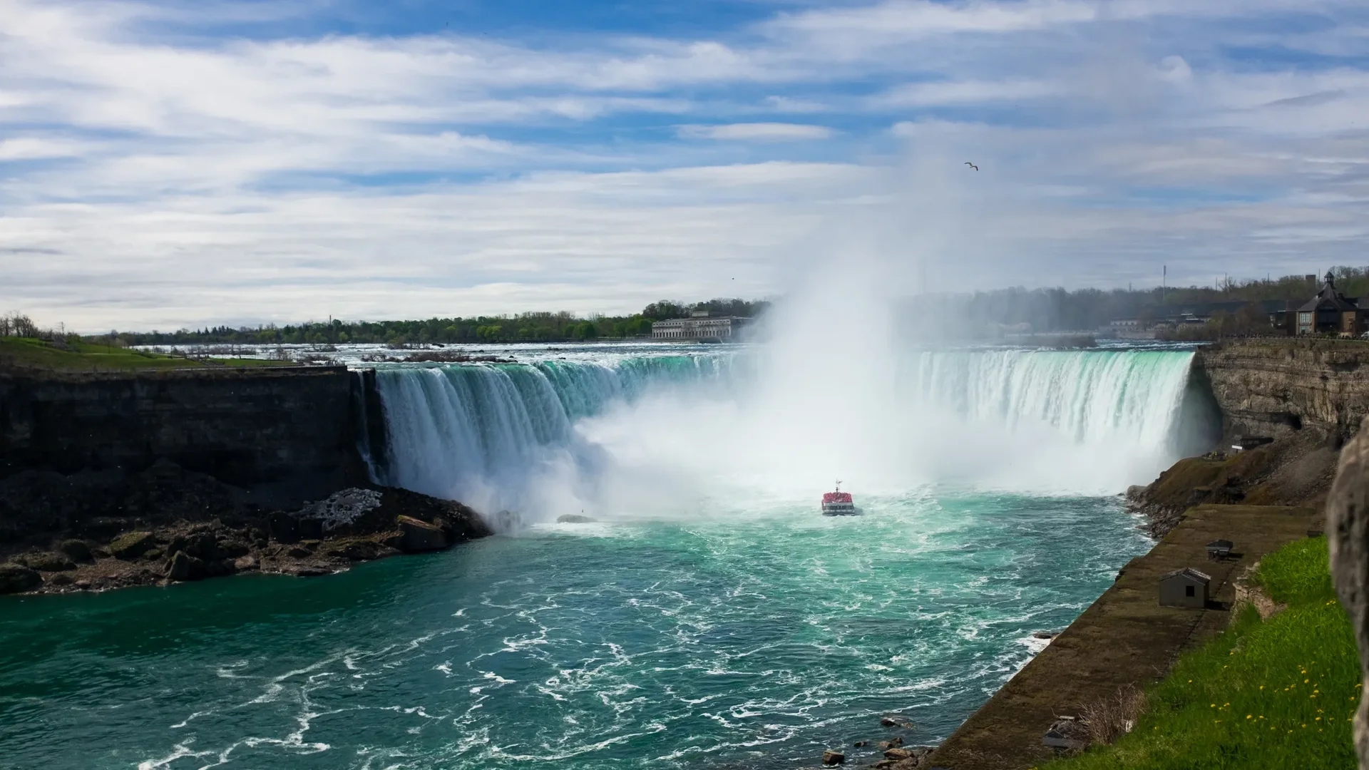 Golden-hour light on the Horseshoe Falls, mist rising over the Canadian side of Niagara